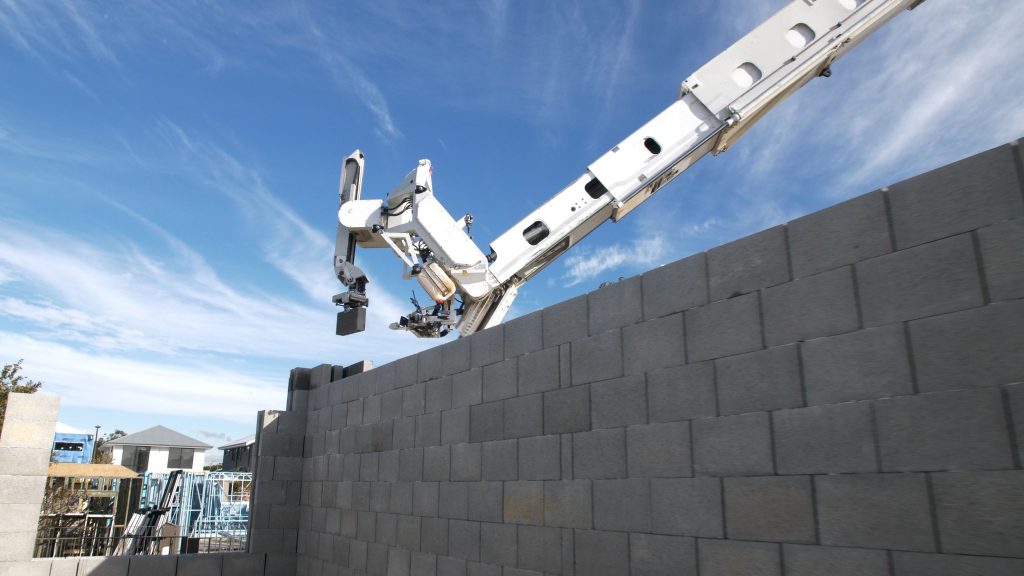 Bricklaying robot behind a wall