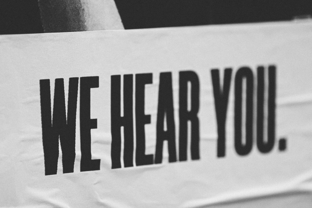 "We hear you" sign representing CX and UX similarity