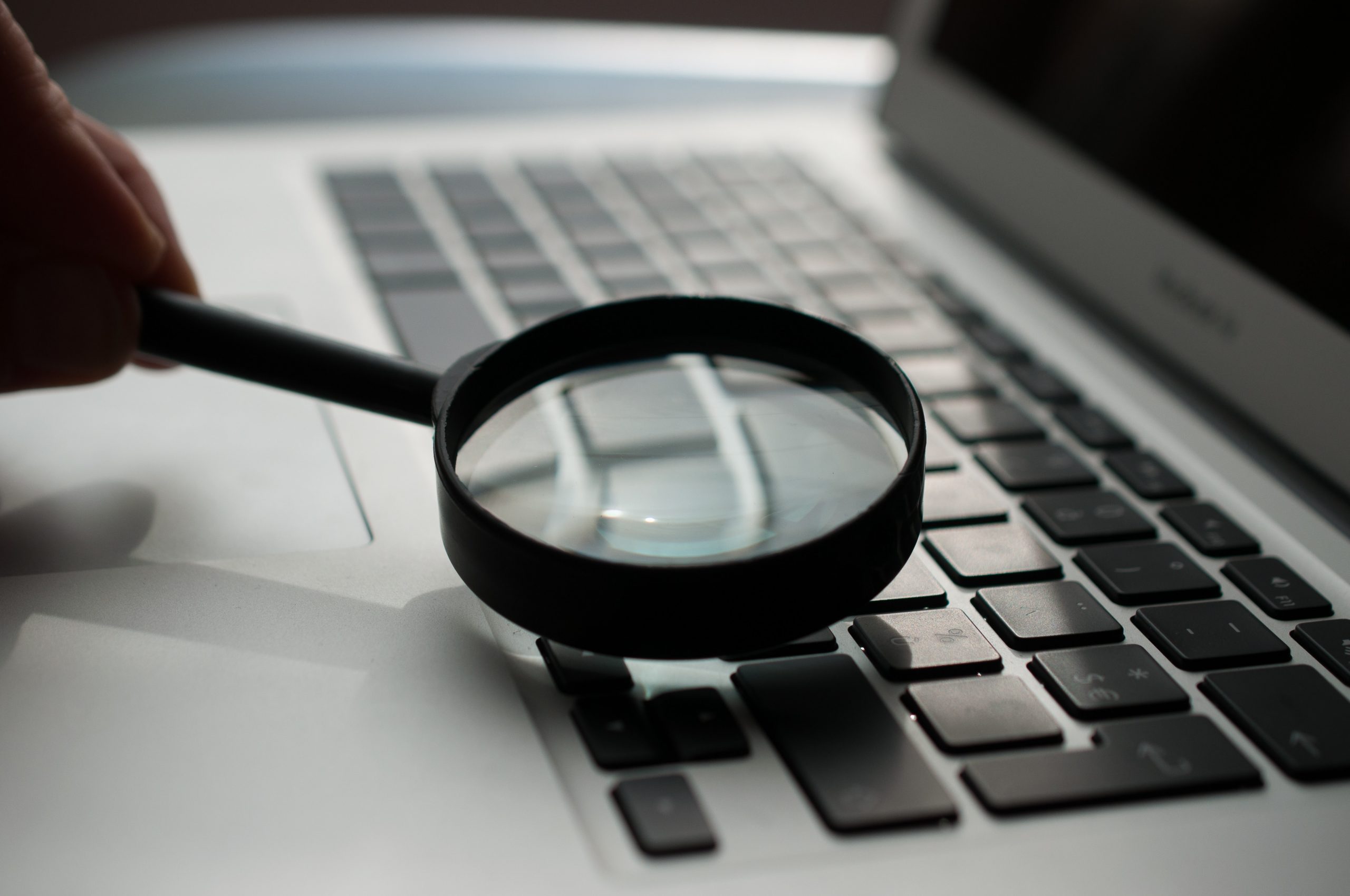 Magnifying glass on top of laptop keyboard