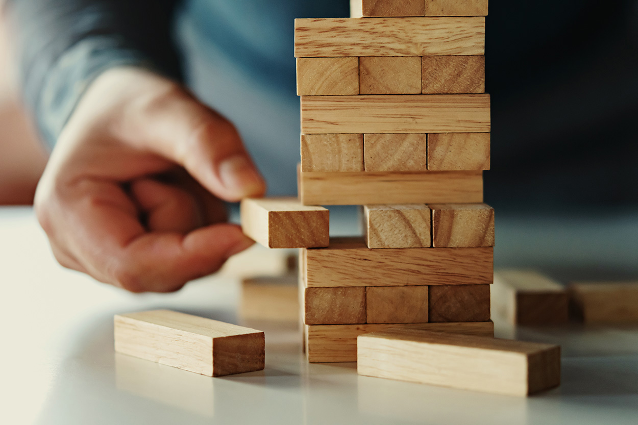 Jenga game as an example of common software development challenges